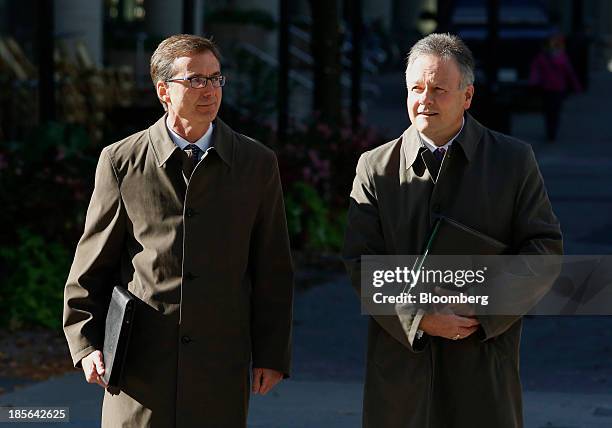 Stephen Poloz, governor of the Bank of Canada, right, and Tiff Macklem, senior deputy governor of the Bank of Canada, wait to cross Bank Street...