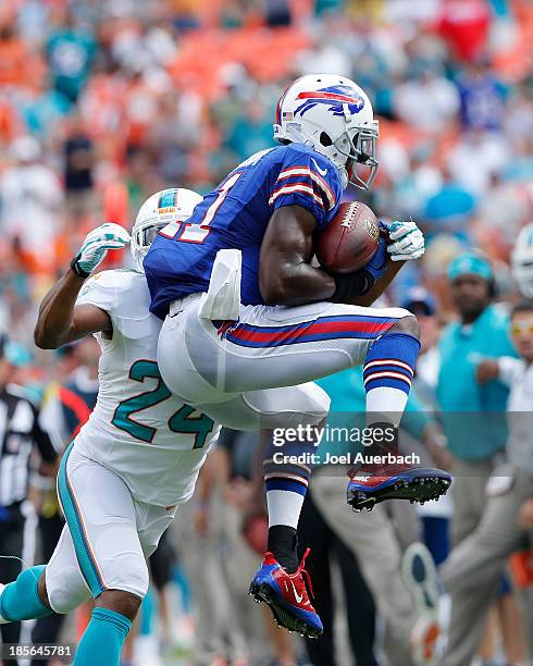 Dimitri Patterson of the Miami Dolphins defends against T.J. Graham of the Buffalo Bills as he catches the ball on October 20, 2013 at Sun Life...