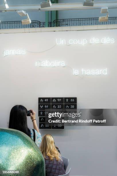 Visitors watch a piece entitled "Un Coup De Des N'Abolira Jamais Le Hasard" during the opening of the 40th edition of the FIAC International...