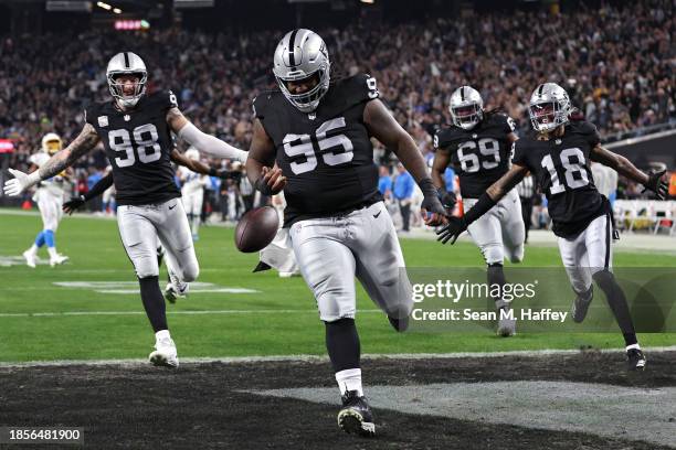 Defensive tackle John Jenkins of the Las Vegas Raiders scores a touchdown against the Los Angeles Chargers during the third quarter at Allegiant...