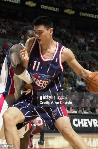 Yao Ming of the Houston Rockets drives against Ben Wallace of the Detroit Pistons during the NBA game at Palace of Auburn Hills on March 4, 2003 in...