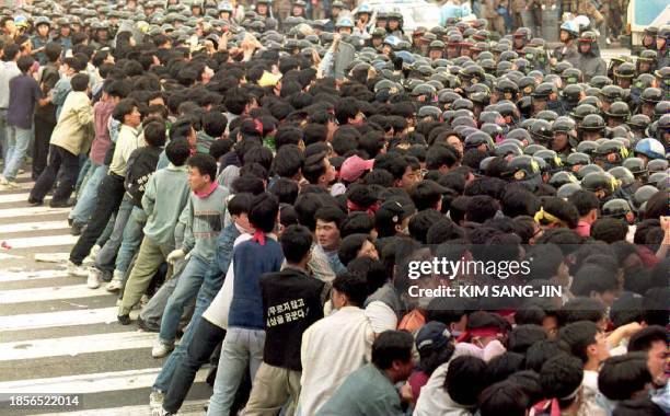 South Korean radical students push through riot policemen 30 April 1994 during an anti-government demonstration. About 2,000 students attended the...