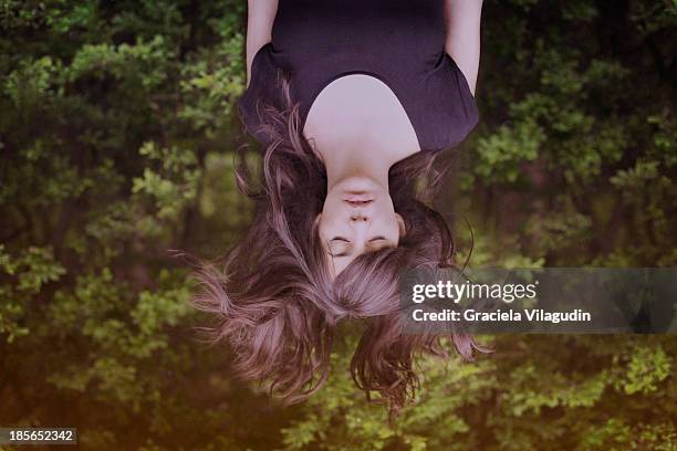 girl upside down with hair flying and eyes closed - 逆さ ストックフォトと画像