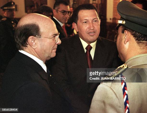 Ipolito Mejias , Dominican Republic President-elect, listens conversation between Venezuelan president, Hugo Chavez , and a military man who escorts...