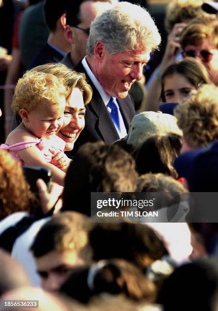 First Lady Hillary Rodham Clinton and President Bill Clinton are greeted by several hundred people who came out to Syracuse Hancock Airport to...