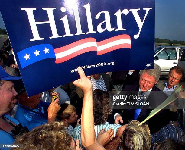 President Bill Clinton greets people who came out to Syracuse Hancock Airport to welcome the him and First Lady Hillary Clinton, 01 September 2000,...