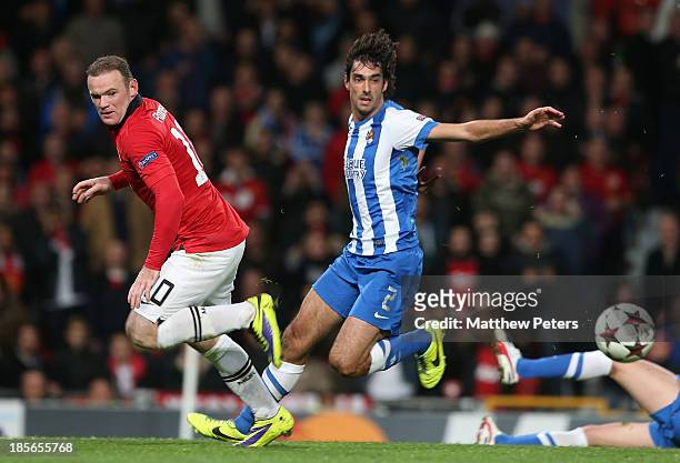 Wayne Rooney of Manchester United in action with Carlos Martinez of Real Sociedad during the UEFA Champions League Group A match between Manchester...