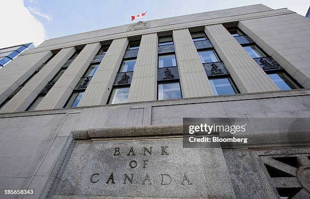 The Canadian flag flies outside the Bank of Canada building in Ottawa, Ontario, Canada, on Wednesday, Oct. 23, 2013. Bank of Canada Governor Stephen...