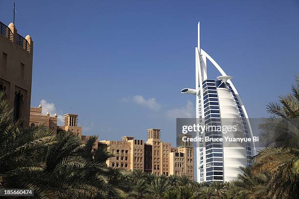 burj al arab hotel with madinat jumeirah in front - al qasr stock pictures, royalty-free photos & images