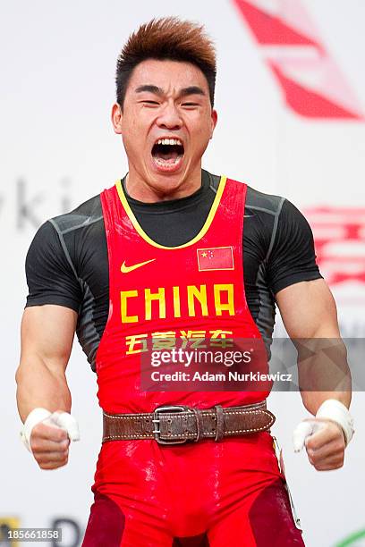 Hui Liao from China celebrates his lift and new world record in the Clean & Jerk competition in men's 69 kg Group A during weightlifting IWF World...