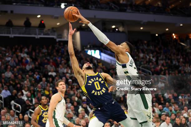 Giannis Antetokounmpo of the Milwaukee Bucks blocks a shot by Tyrese Haliburton of the Indiana Pacers during the first half of a game at Fiserv Forum...