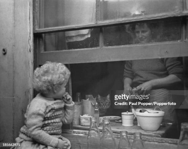 Caitlin Thomas , wife of Welsh poet and writer Dylan Thomas, with their daughter, Aeronwy at their home, the Boat House in Laugharne,...