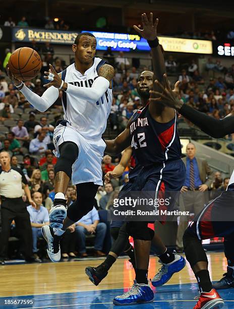 Monta Ellis of the Dallas Mavericks pass the ball against Elton Brand of the Atlanta Hawks at American Airlines Center on October 23, 2013 in Dallas,...