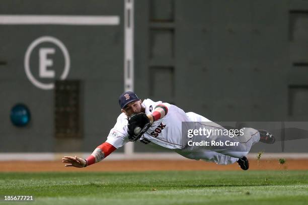 Jonny Gomes of the Boston Red Sox catches a ball hit by Matt Adams of the St. Louis Cardinals in the fifth inning of Game One of the 2013 World...