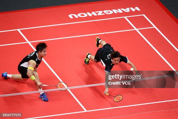 Liang Weikeng and Wang Chang of China compete in the Men's Doubles Round Robin match against Aaron Chia and Soh Wooi Yik of Malaysia on day 3 of the...