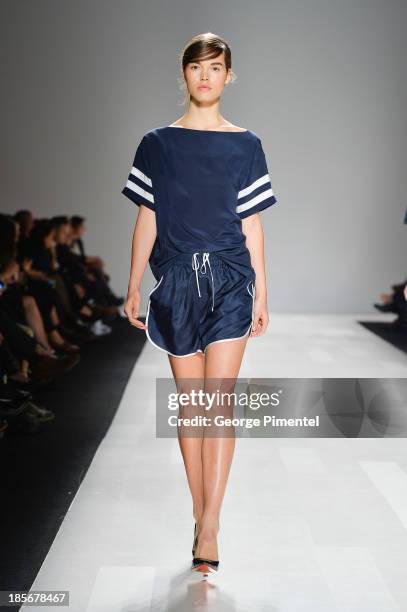 Model walks the runway wearing Joe Fresh spring 2014 collection during World MasterCard Fashion Week Spring 2014 at David Pecaut Square on October...