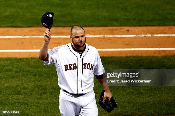 Jon Lester of the Boston Red Sox tips his cap as he leaves the game in the eighth inning against the St. Louis Cardinals during Game One of the 2013...