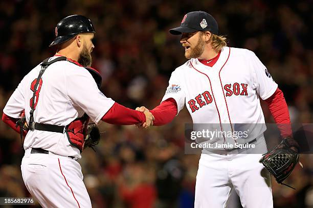 Ryan Dempster and David Ross of the Boston Red Sox celebrate after defeating the St. Louis Cardinals 8-1 in Game One of the 2013 World Series at...