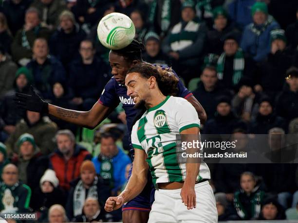 Christian Kouame of ACF Fiorentina battles for possession in the air with Cebrails Makreckis of Ferencvarosi TC during the UEFA Europa Conference...