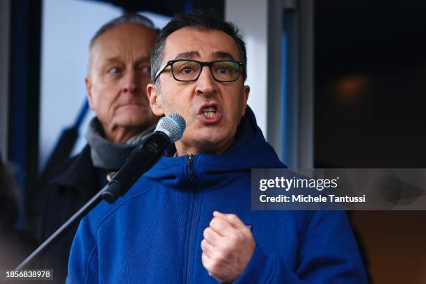 Food and Agriculture Minister Cem Oezdemir speaks as Farmers arrive on their tractors at the Brandenburg Gate to protest against planned cuts to...