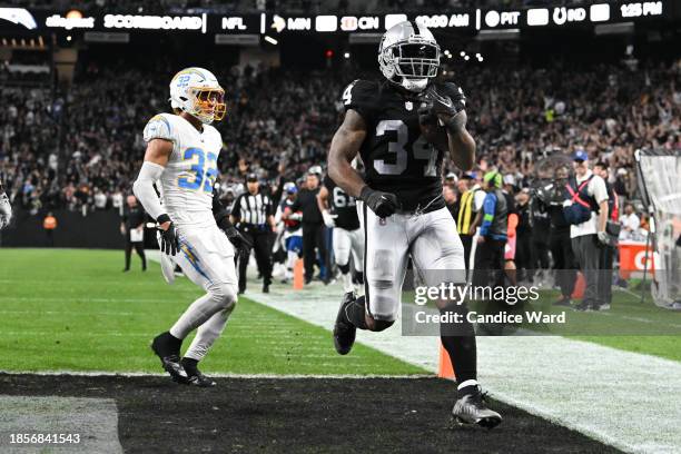 Running back Brandon Bolden of the Las Vegas Raiders scores a touchdown against the Los Angeles Chargers during the second quarter at Allegiant...