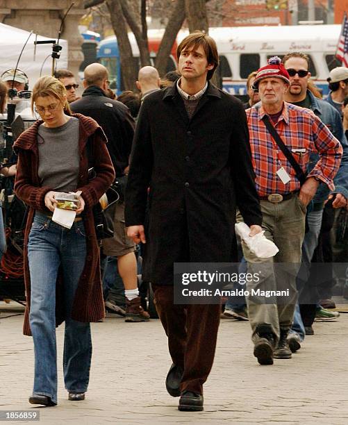 Actor Jim Carrey and co-star Ellen Pompeo walk on set of the film
