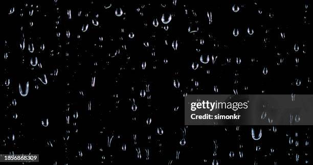 close-up of raindrops on glass - raindrop stock pictures, royalty-free photos & images