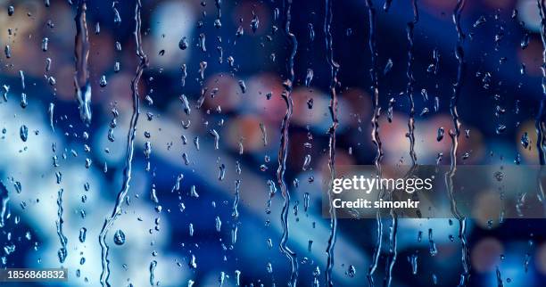 close-up of raindrops on window - bad weather on window stock pictures, royalty-free photos & images
