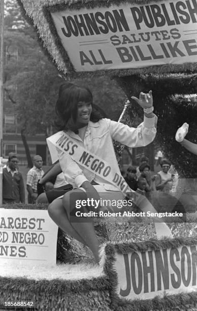 View of Miss Negro Digest and others as they ride the Johnson Publishing float, during the Bud Billiken Day parade, Chicago, Illinois, mid to late...