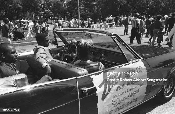 View showing the car sponsored by the Zeker Sign Company, a local business, during the Bud Billiken Day parade, Chicago, Illinois, mid to late 1960s .