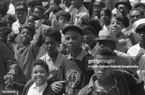 View showing the crowds lined up along the street to watch the Bud Billiken Day parade, Chicago, Illinois, mid to late 1960s .