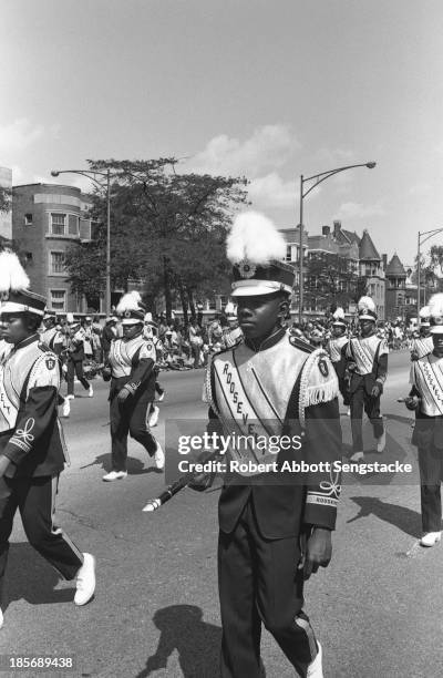 View showing the high school marching band for Roosevelt, participating in the Bud Billiken Day parade, Chicago, Illinois, mid to late 1960s .