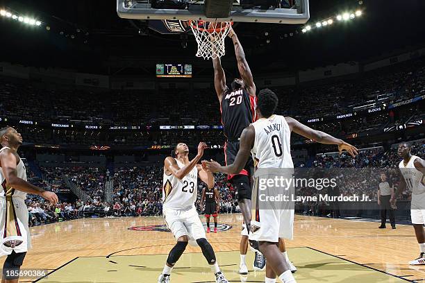 Greg Oden of the Miami Heat dunks the ball against the New Orleans Pelicans during an NBA preseason game on October 23,2013 at the New Orleans Arena...