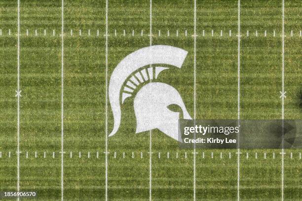 The Michigan State Spartans logo at midfield of Spartan StadiumDecember 07, 2023 in East Lansing, Michigan.