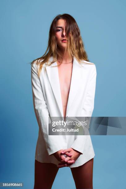 young woman in white blazer on colored background, with hair over her face. - no pants day photos et images de collection