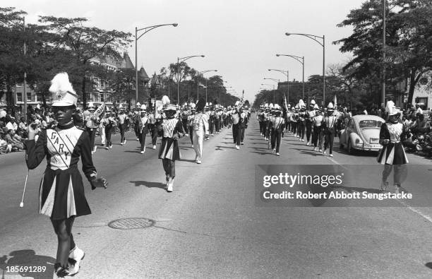 View showing a high school marching band from Gary, Indiana as it participates in the Bud Billiken Day parade, Chicago, Illinois, mid to late 1960s .