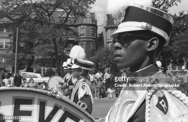 Close-up view showing a drummer from the Roosevelt marching band, while participating in the Bud Billiken Day parade, Chicago, Illinois, mid to late...