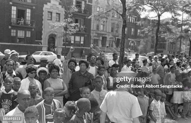 View showing the crowds lined up along the street to watch the Bud Billiken Day parade, Chicago, Illinois, mid to late 1960s .