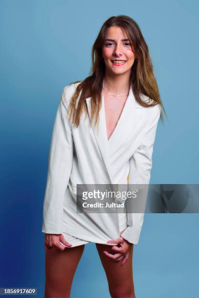smiling young woman in white blazer on colored background, in the studio. - no pants day photos et images de collection