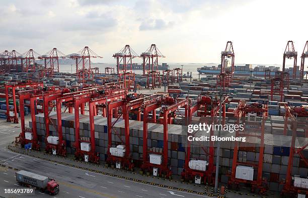 Truck carrying an A.P. Moeller-Maersk A/S shipping container drives through the Yangshan Deep Water Port, part of China Pilot Free Trade Zone's...