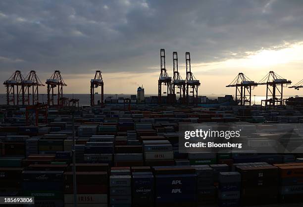 Shipping containers are stacked at the Yangshan Deep Water Port, part of China Pilot Free Trade Zone's Yangshan free trade port area, in Shanghai,...