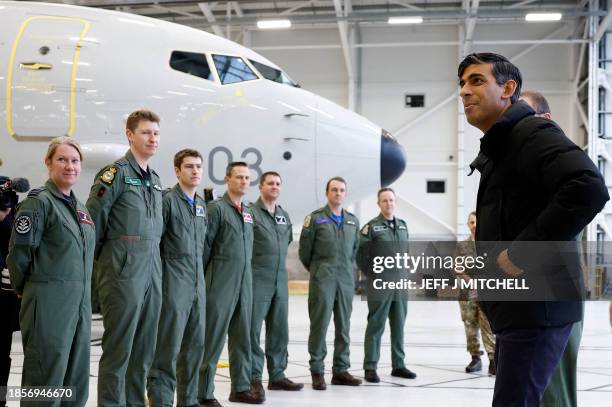 Britain's Prime Minister Rishi Sunak meets with RAF military personnel in an aircraft hangar during his visit to Royal Air Force base Lossiemouth in...