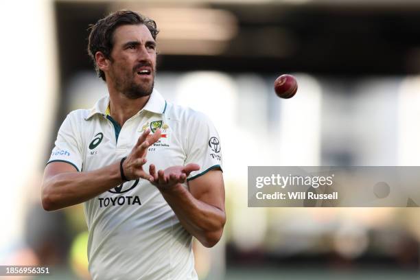 Mitchell Starc of Australia receives the ball during day two of the Men's First Test match between Australia and Pakistan at Optus Stadium on...