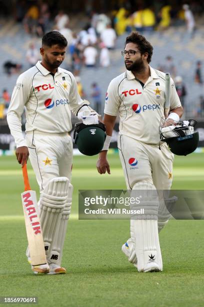 Khurram Shahzad and Imam-ul-Haq of Pakistan leave the field at end of play during day two of the Men's First Test match between Australia and...