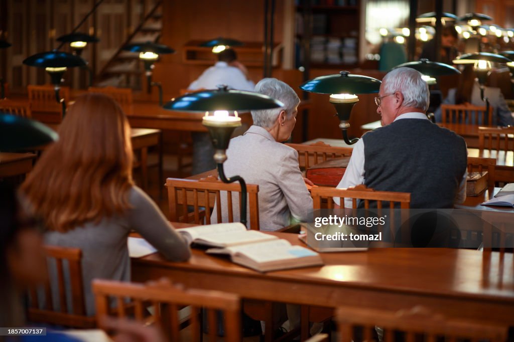 People in library reading room