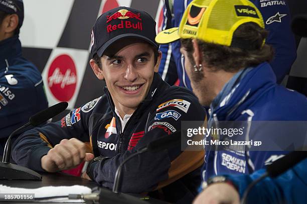 Marc Marquez of Spain and Repsol Honda Team speaks with Valentino Rossi of Italy and Yamaha Factory Racing during the press conference ahead of the...