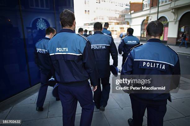 Romanian police officers stand outside Scotland Yard on October 24, 2013 in London, England. Eight Romanian and three Polish officers are to work in...