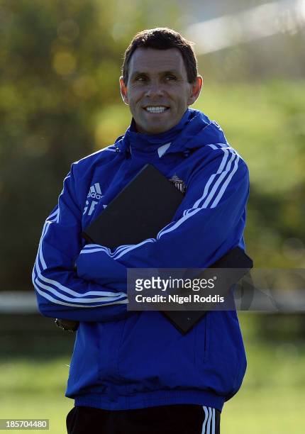 Manager Gus Poyet of Sunderland speaks to his players during their training session at the Academy of Light on October 24, 2013 in Sunderland,...
