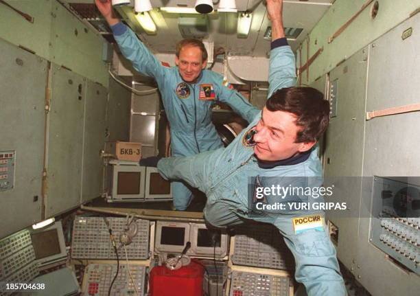 This December 1994 file photo shows US astronaut Norman E.Thagard floating inside the MIR orbital station with Russian Cosmonaut Vladimir Dezhurov at...