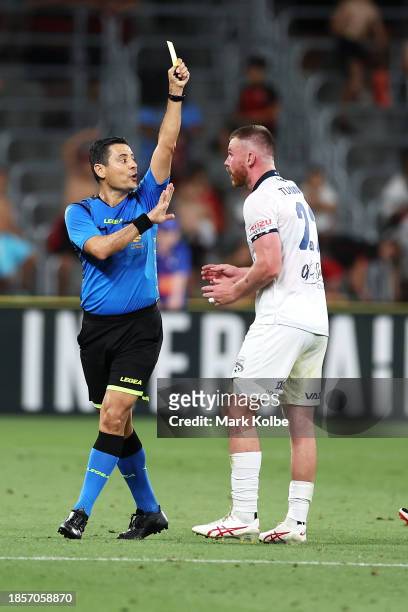 Referee Alireza Faghani shows Ryan Tunnicliffe of United a yellow card during the A-League Men round eight match between Western Sydney Wanderers and...